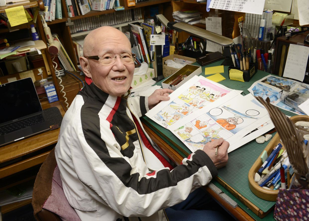 Tetsuya Chiba poses for a photo at his desk in his studio in Tokyo in November 2022. Photo: AP 
