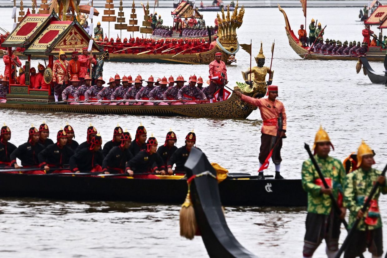 Oarsmen rowing barges along the Chao Phraya River during the full dress rehearsal for the Royal Barge Procession in honour of Thailand's Queen Suthida in Bangkok on Oct 28. -AFP
