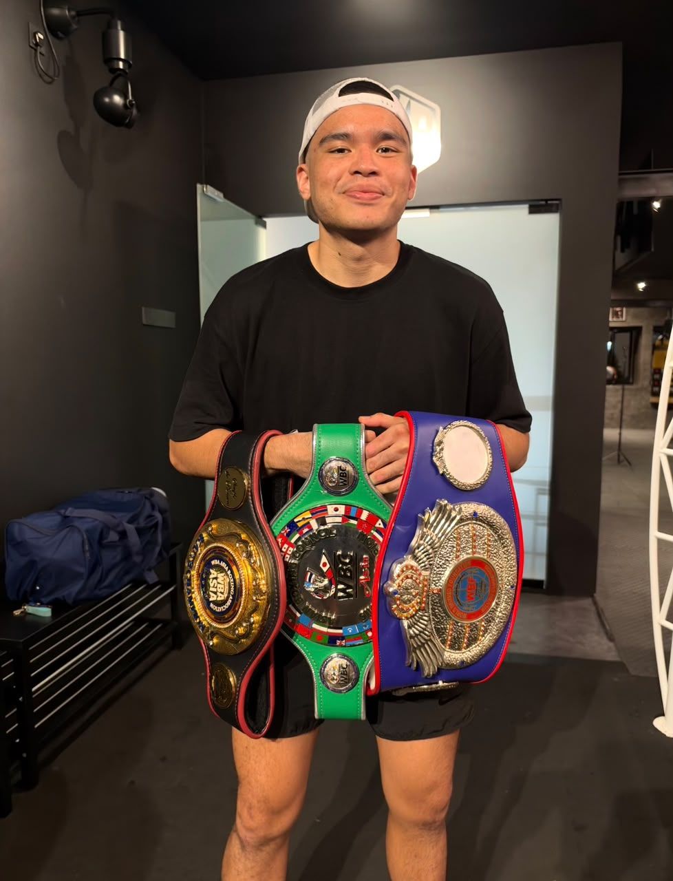 Good season: Adam posing with his title belts won this year.