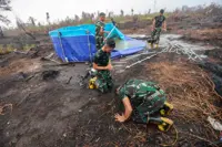 Rains bring relief to Indonesian city weary of fire haze