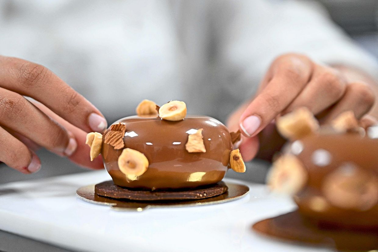 Finishing touches: A student chef preparing a dessert pastry. — AFP