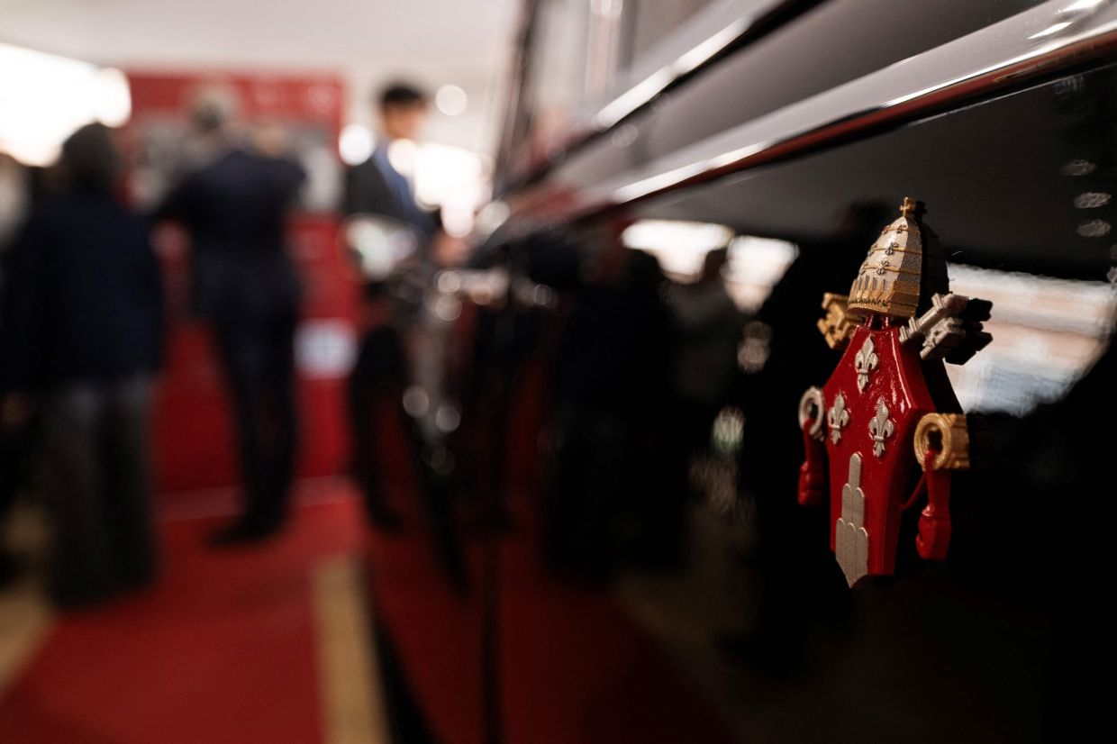 A photograph shows the Emblem of the Holy See on one of the historic papal vehicles on display at the exhibition. Photo: AP