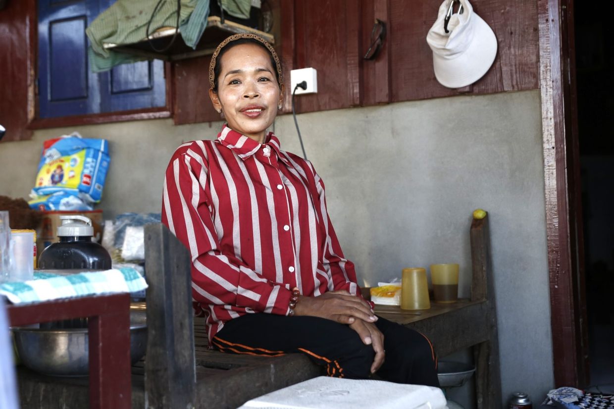 Ek Sophon’s daughter, who has a mobility disability, relies on income from the family’s small grocery business operated from their home. - Photo: The Phnom Penh Post/ANN