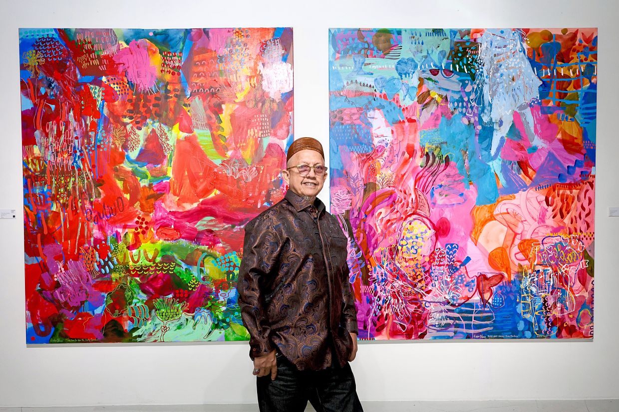 Rafiee with his new mixed media works 'It’s Time To Open The Ruby Gates' (left) and 'Polka-dot Dancer From The Farm' at Galeri Puteh in Kuala Lumpur. Photo: The Star/Faihan Ghani