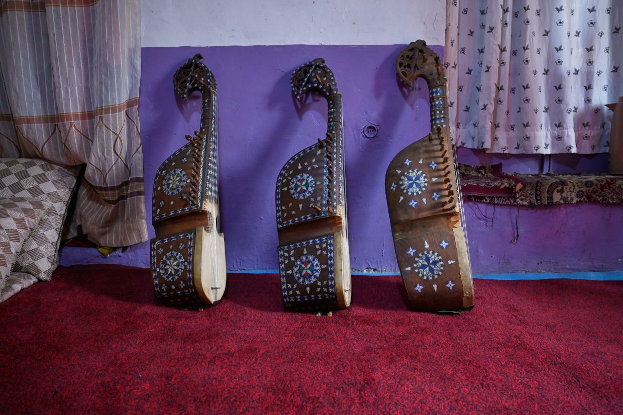 Rubabs, traditional stringed instruments belonging to a former music teacher who closed his family's instrument shop following the Taliban takeover in 2021, lean against a wall in Kabul, Afghanistan. Photo: AP