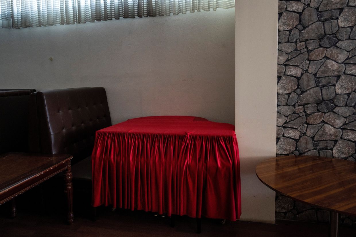 A red cloth covers a grand piano in a hookah bar in Kabul, Afghanistan. Photo: AP
