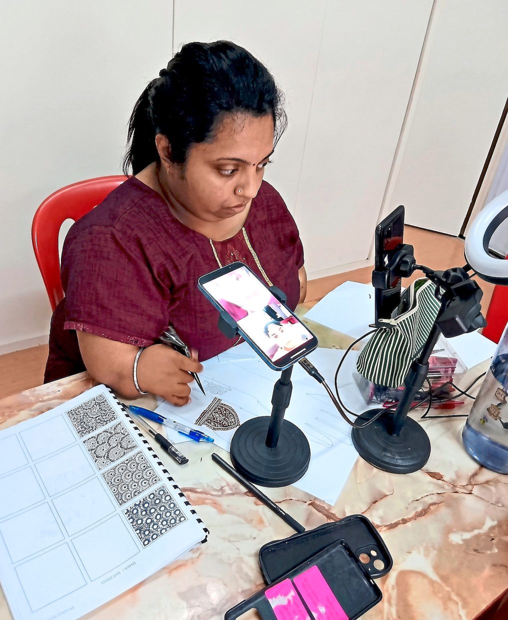 Forging ahead: Namvinsha conducting a live session on social media to promote her henna services. — Photo courtesy of Namvinsha